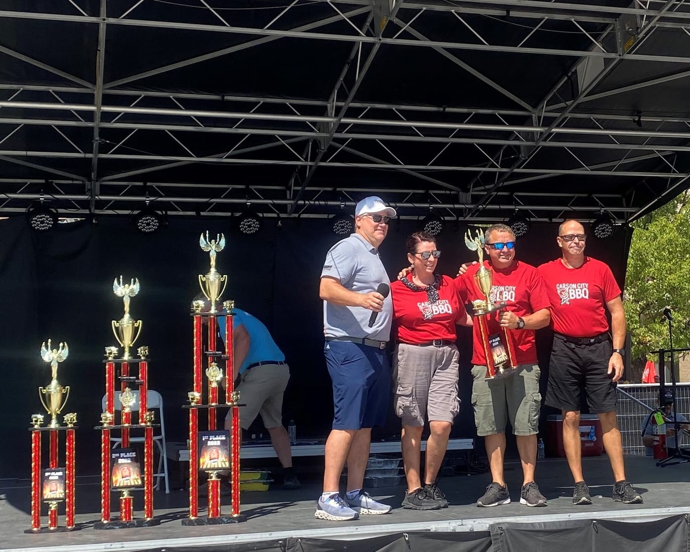 The Carson City BBQ crew on stage with their trophies at a rib cook-off