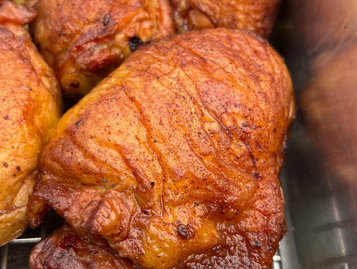 Golden rotisserie-roasted chicken pieces stacked together, their skin crisp and burnished.